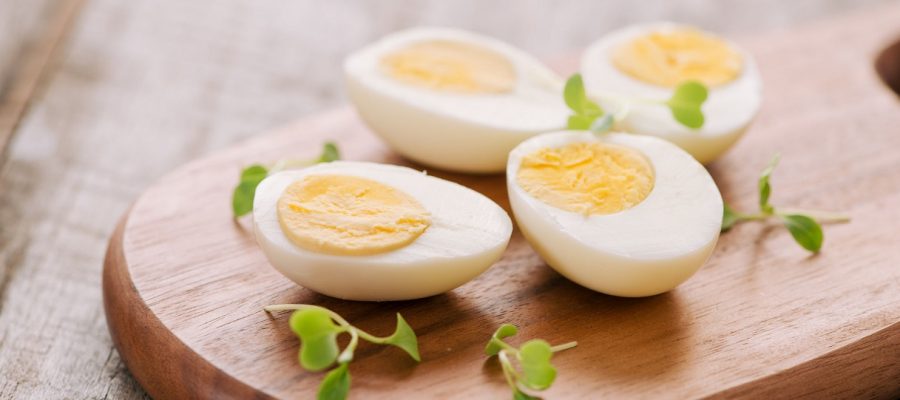 Boiled eggs on cutting board. Selective focus, space for text
